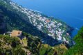 Pobre�n� z�stavba na strm�ch zelen�ch svahoch nad modr�m morom