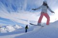 Osoba na snowboarde na hrane snehovej vlny s horami v pozad�
